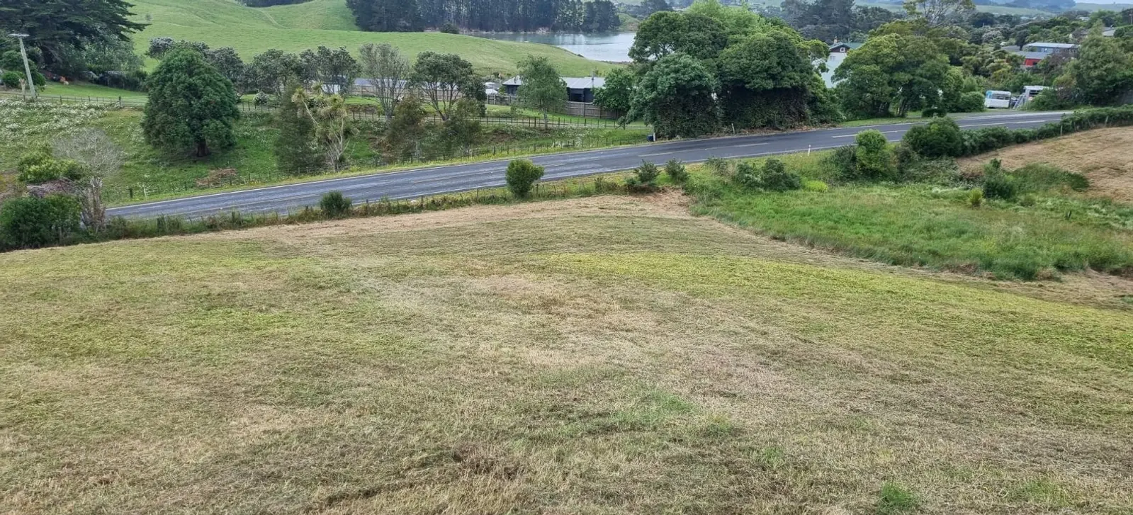 Sloping rural block beside the road, photographed before earthworks begin