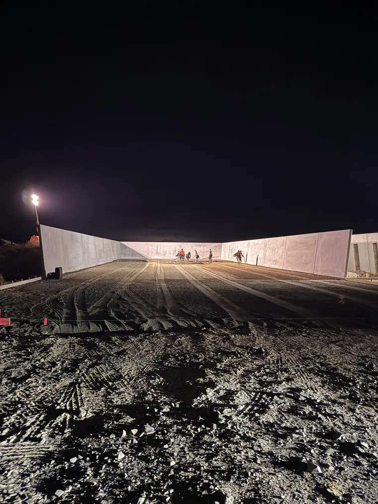 Silage bunker walls at night with the base graded and ready for concrete